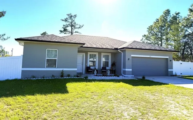 a view of a house with swimming pool and a yard