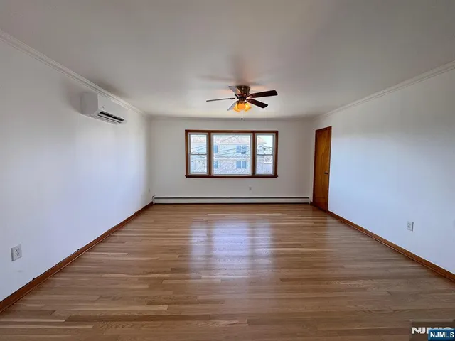a view of an empty room and wooden floor