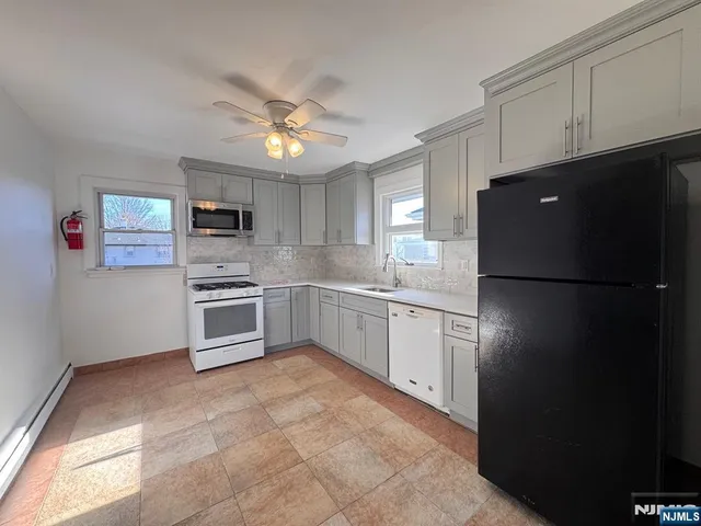 a kitchen with a refrigerator a sink and dishwasher