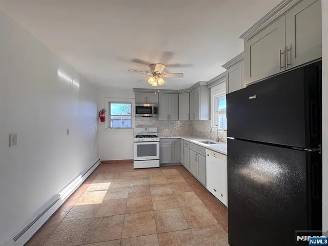 a kitchen with a stove a sink and a refrigerator