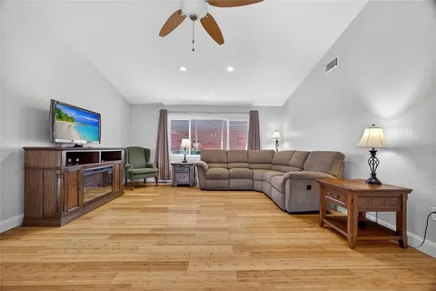a living room with furniture and a wooden floor