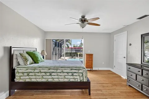 a bedroom with a large bed and a chandelier