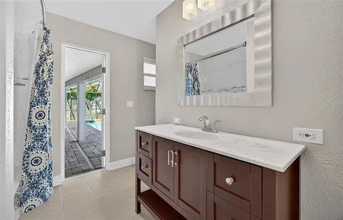 a bathroom with a sink vanity and mirror
