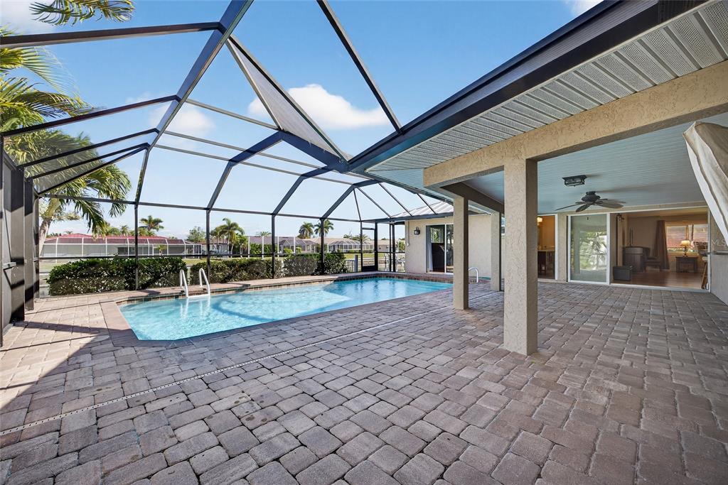 926 Genoa Court Punta Gorda, FL 33950 - Photo 25 of 41 a view of a patio with table and chairs under an umbrella