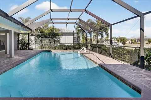 a view of a living room with a floor to ceiling window and wooden floor