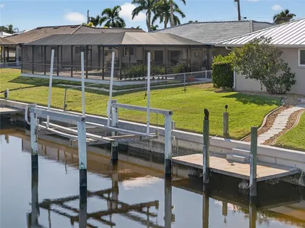 a view of a house with swimming pool and porch with furniture