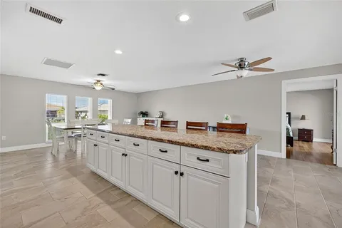 a kitchen with granite countertop a sink and cabinets