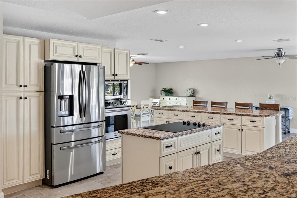 926 Genoa Court Punta Gorda, FL 33950 - Photo 8 of 41 a kitchen with white cabinets and stainless steel appliances