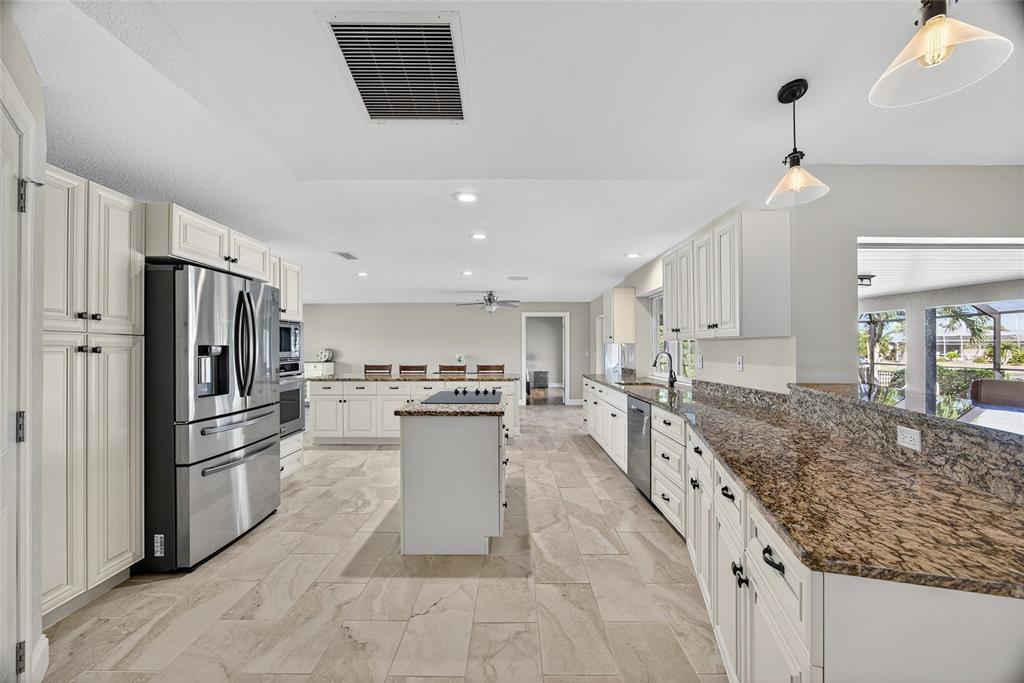 926 Genoa Court Punta Gorda, FL 33950 - Photo 9 of 41 a kitchen with stainless steel appliances granite countertop a sink stove and refrigerator