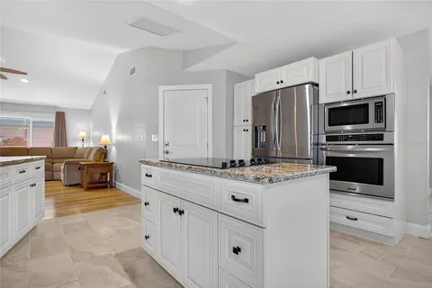 a kitchen with stainless steel appliances a stove microwave and refrigerator