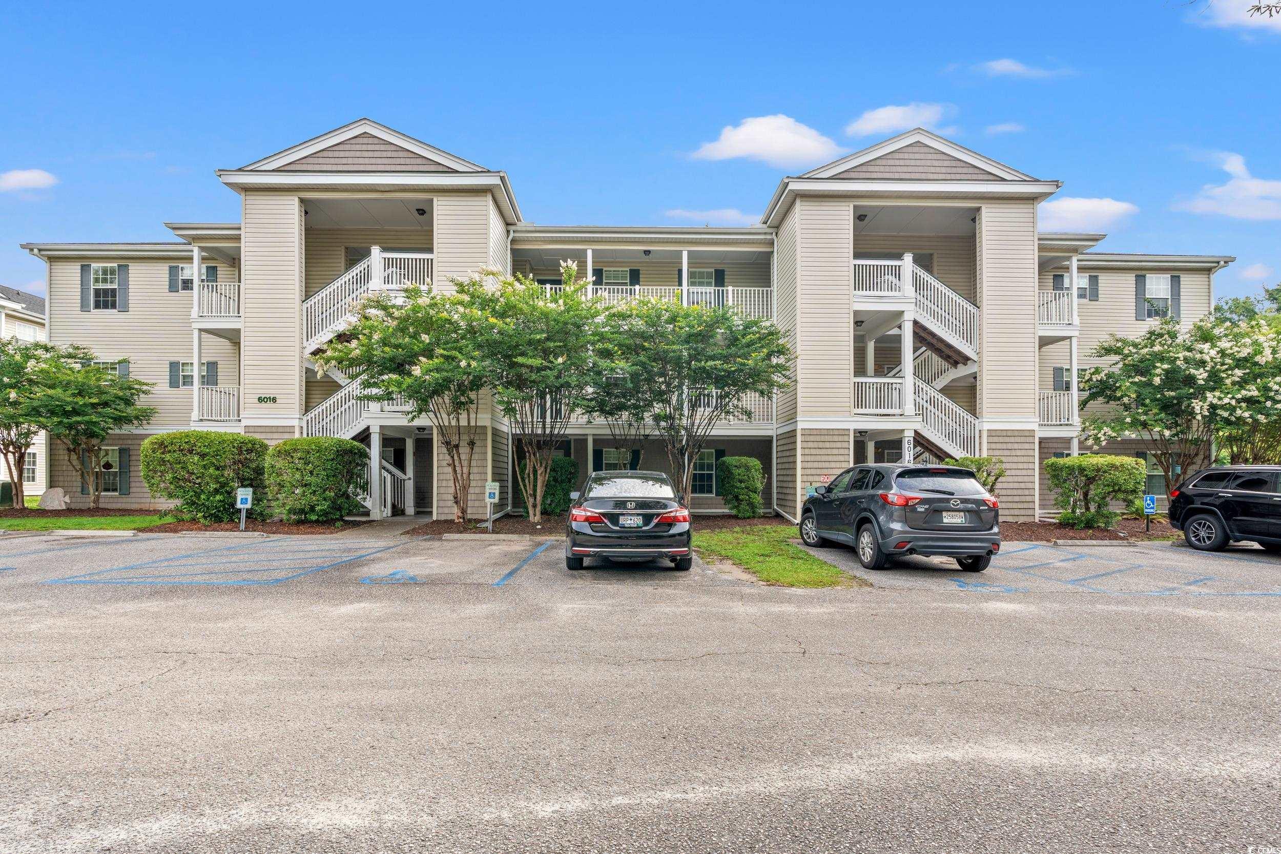 6016 Dick Pond Road, Unit 109 Myrtle Beach, SC 29588 - Photo 1 of 35 View of building exterior featuring stairway and u