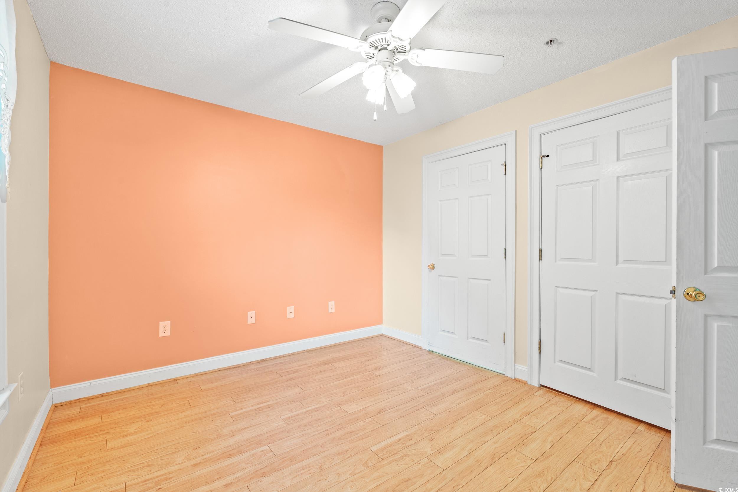 6016 Dick Pond Road, Unit 109 Myrtle Beach, SC 29588 - Photo 17 of 35 Unfurnished bedroom with light wood-style floors,