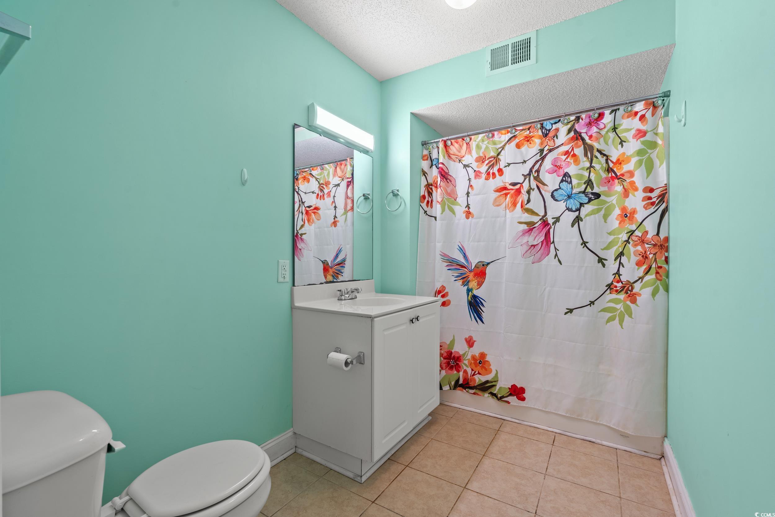 6016 Dick Pond Road, Unit 109 Myrtle Beach, SC 29588 - Photo 20 of 35 Bathroom with toilet, vanity, tile patterned floor