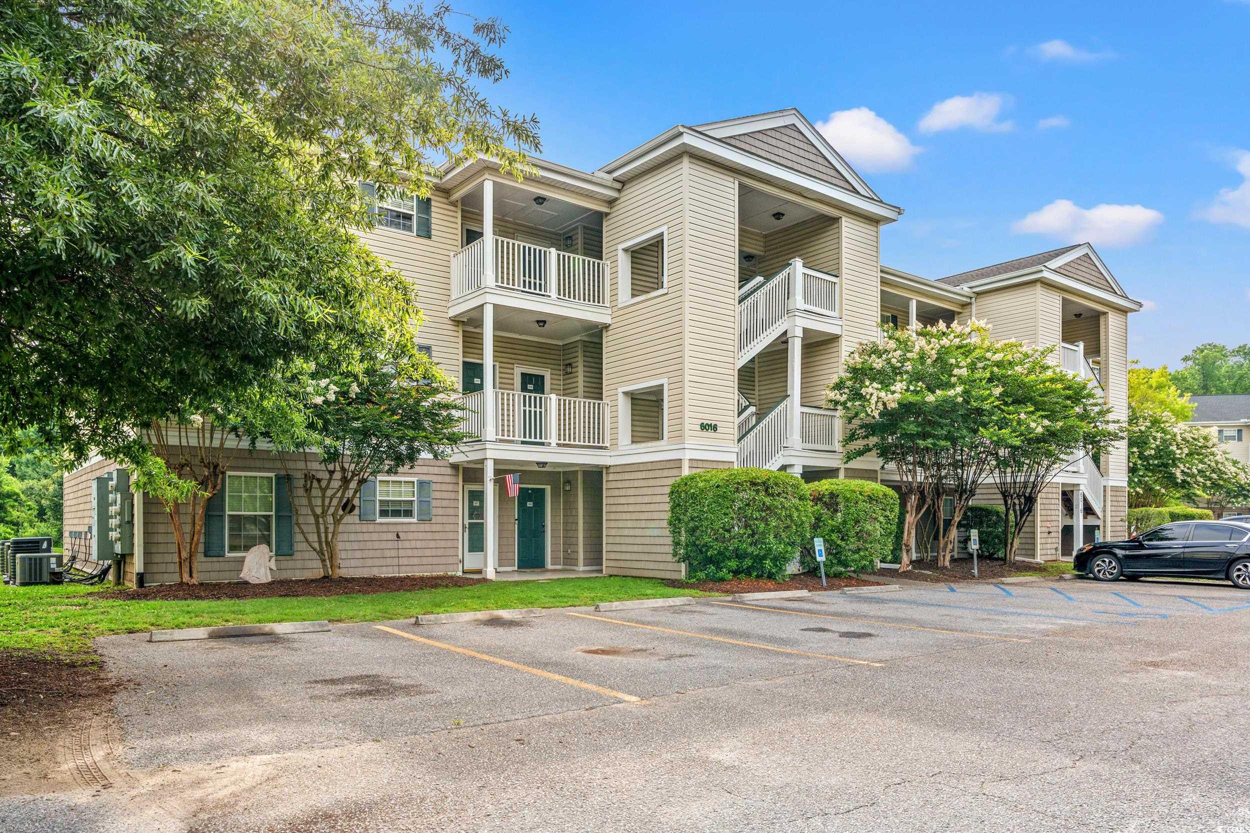 6016 Dick Pond Road, Unit 109 Myrtle Beach, SC 29588 - Photo 2 of 35 View of property with uncovered parking and centra