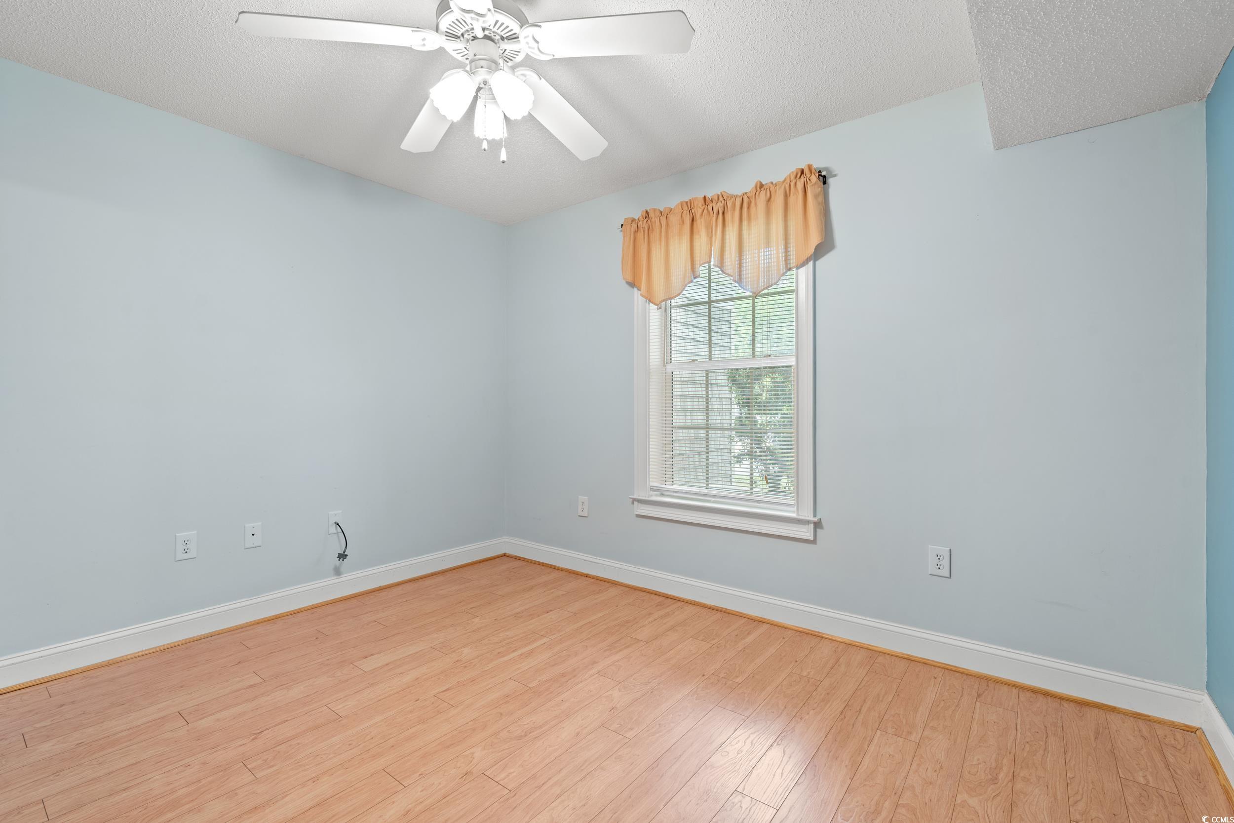 6016 Dick Pond Road, Unit 109 Myrtle Beach, SC 29588 - Photo 22 of 35 Spare room featuring wood finished floors, baseboa