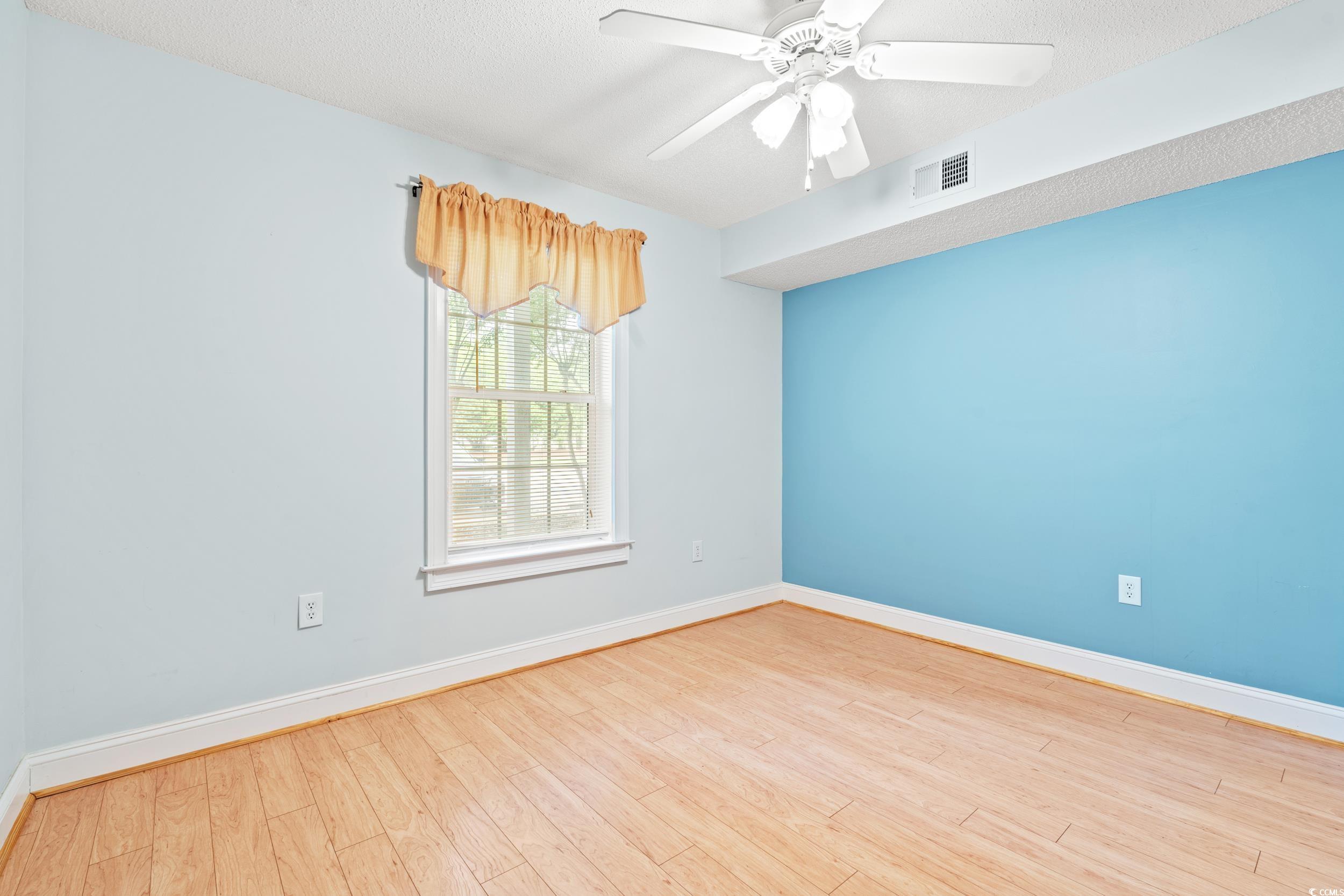 6016 Dick Pond Road, Unit 109 Myrtle Beach, SC 29588 - Photo 24 of 35 Spare room with wood finished floors, baseboards,