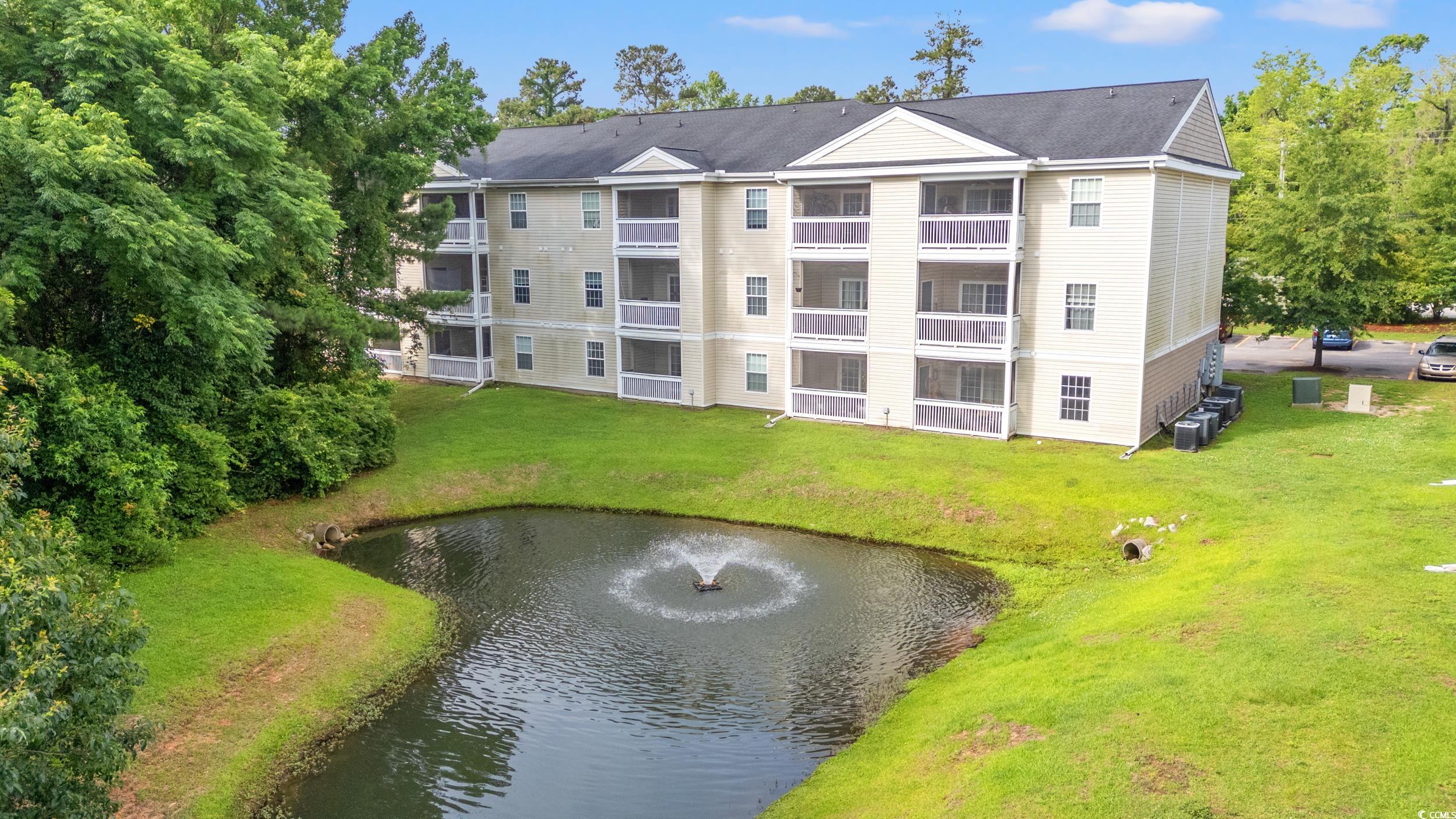 6016 Dick Pond Road, Unit 109 Myrtle Beach, SC 29588 - Photo 28 of 35 View of building exterior with a water view and co