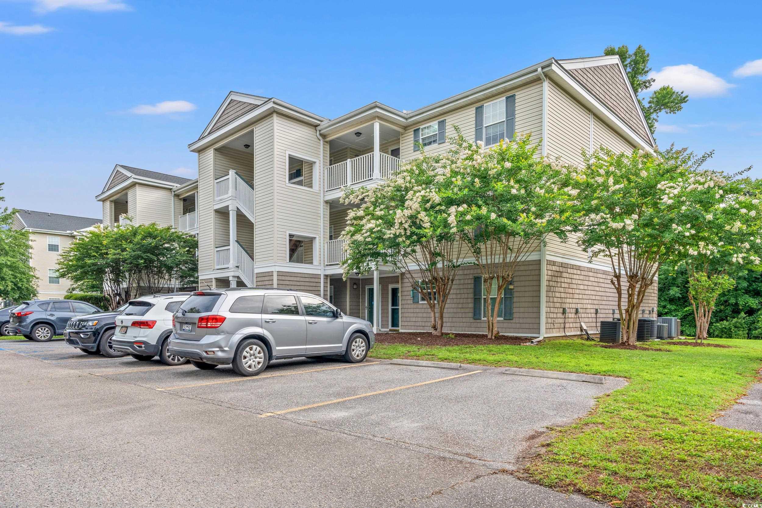 6016 Dick Pond Road, Unit 109 Myrtle Beach, SC 29588 - Photo 29 of 35 View of building exterior featuring uncovered park