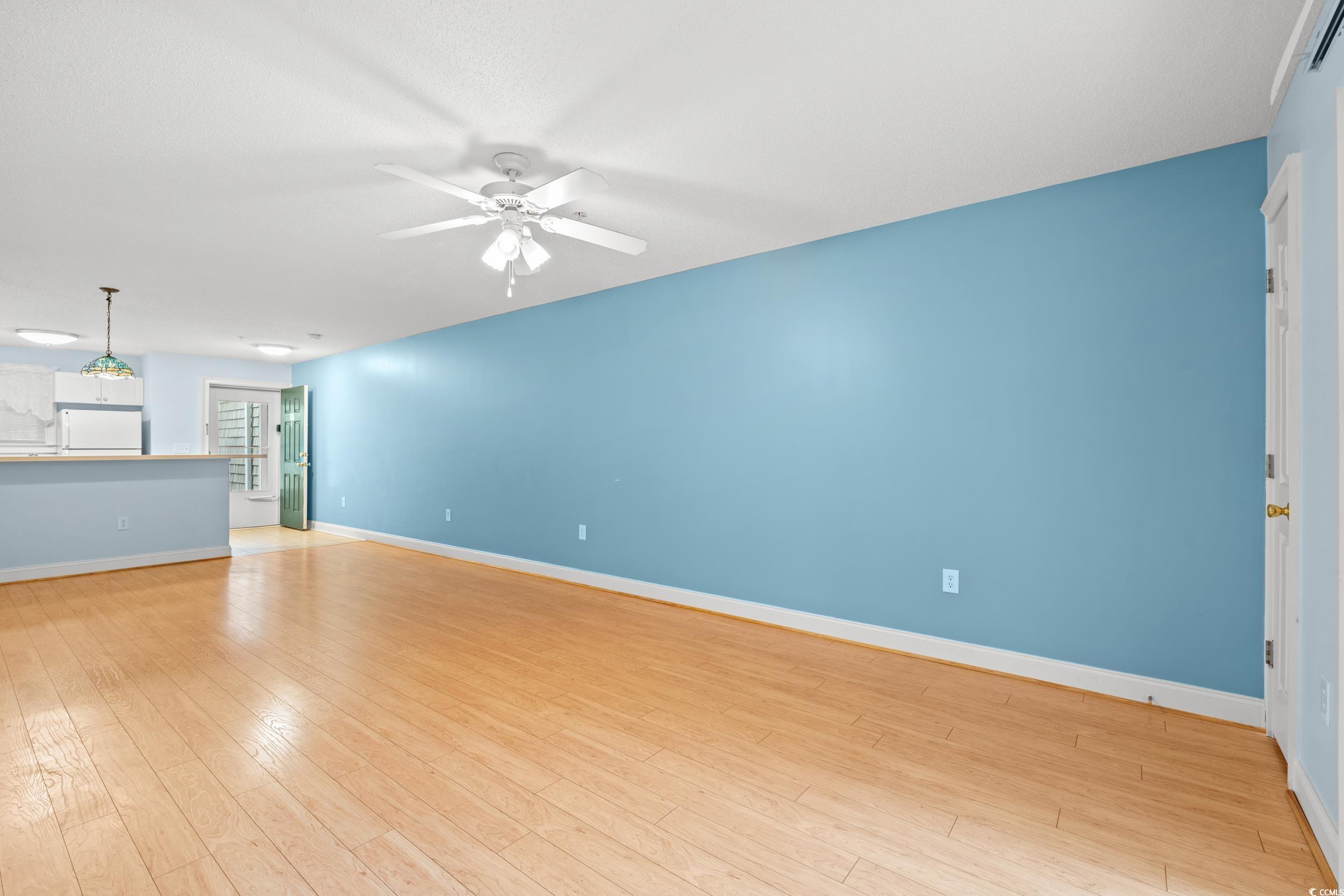 6016 Dick Pond Road, Unit 109 Myrtle Beach, SC 29588 - Photo 6 of 35 Unfurnished living room with ceiling fan, light wo