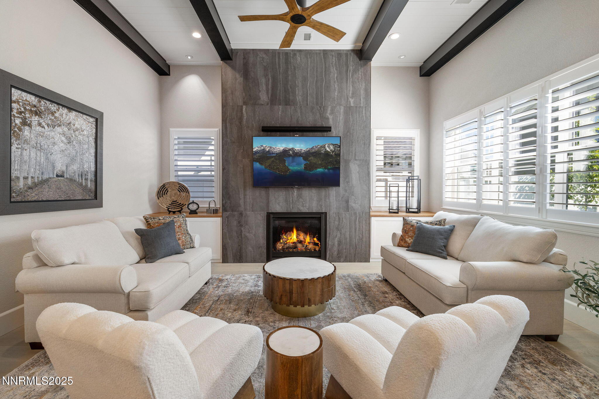 a living room with furniture a fireplace and window