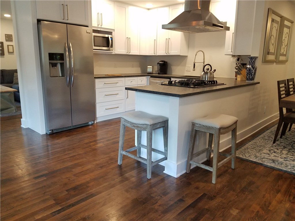 5405 Hudson Street Austin, TX 78721 - Photo 21 of 37 A well-lit kitchen with sleek stainless steel appliances and a convenient breakfast bar for casual dining.