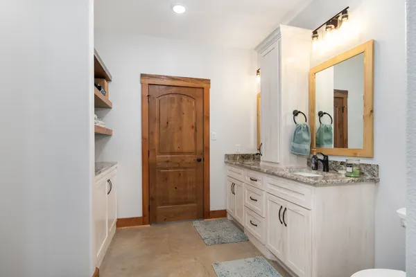 a bathroom with a double vanity sink and mirror