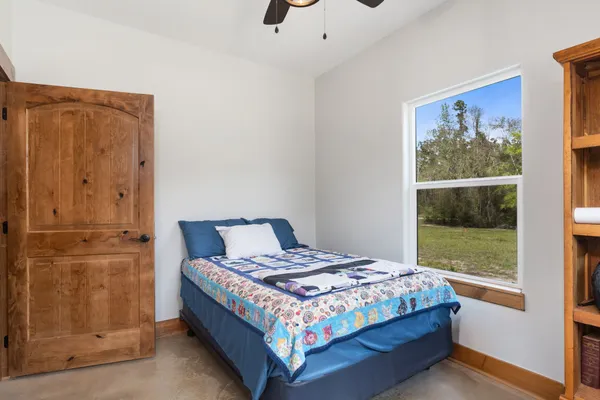 a bedroom with a bed and window