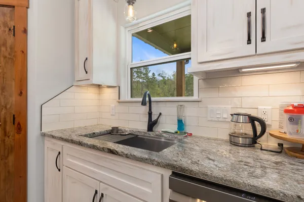 a kitchen with sink and window