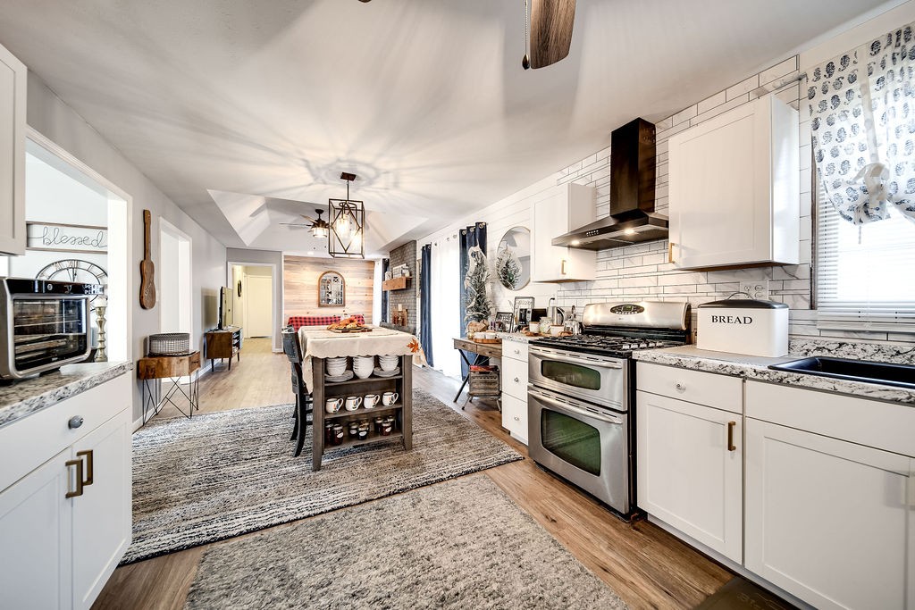 4468 Mt Zion Road Springfield, TN 37172 - Photo 13 of 48 a kitchen with stainless steel appliances a stove a sink dishwasher a dining table and chairs with wooden floor