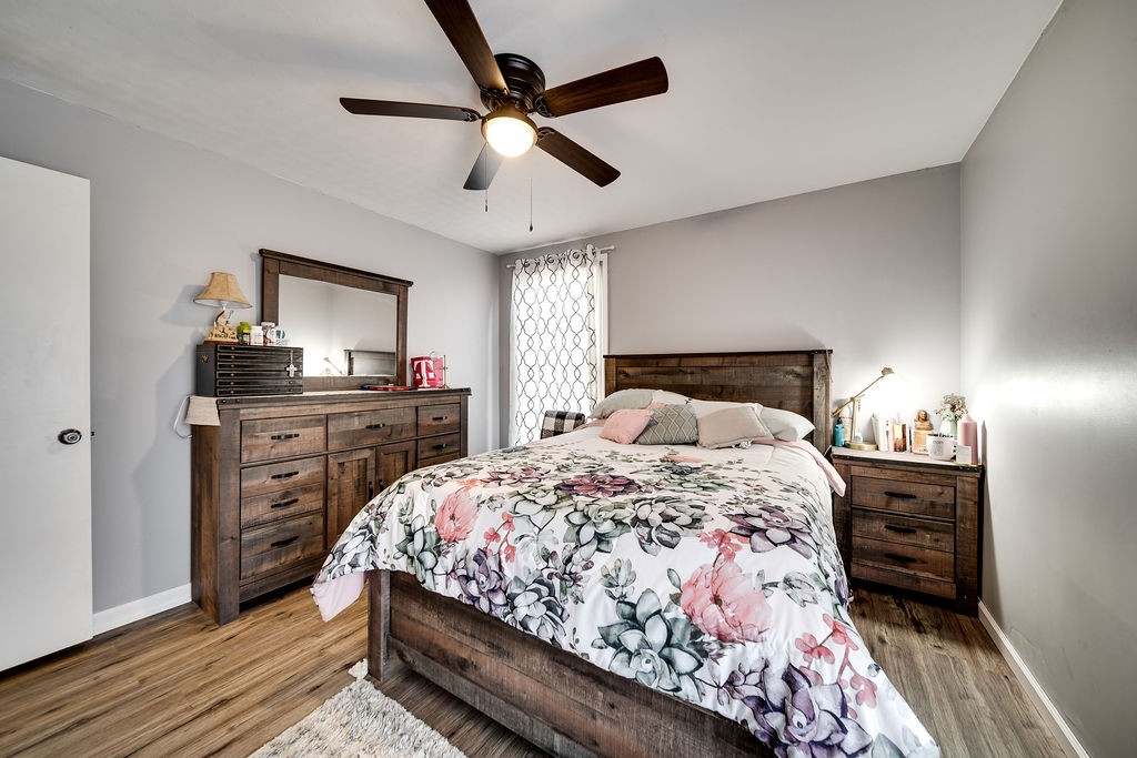 4468 Mt Zion Road Springfield, TN 37172 - Photo 29 of 48 a bedroom with a bed and a flat tv screen on dresser