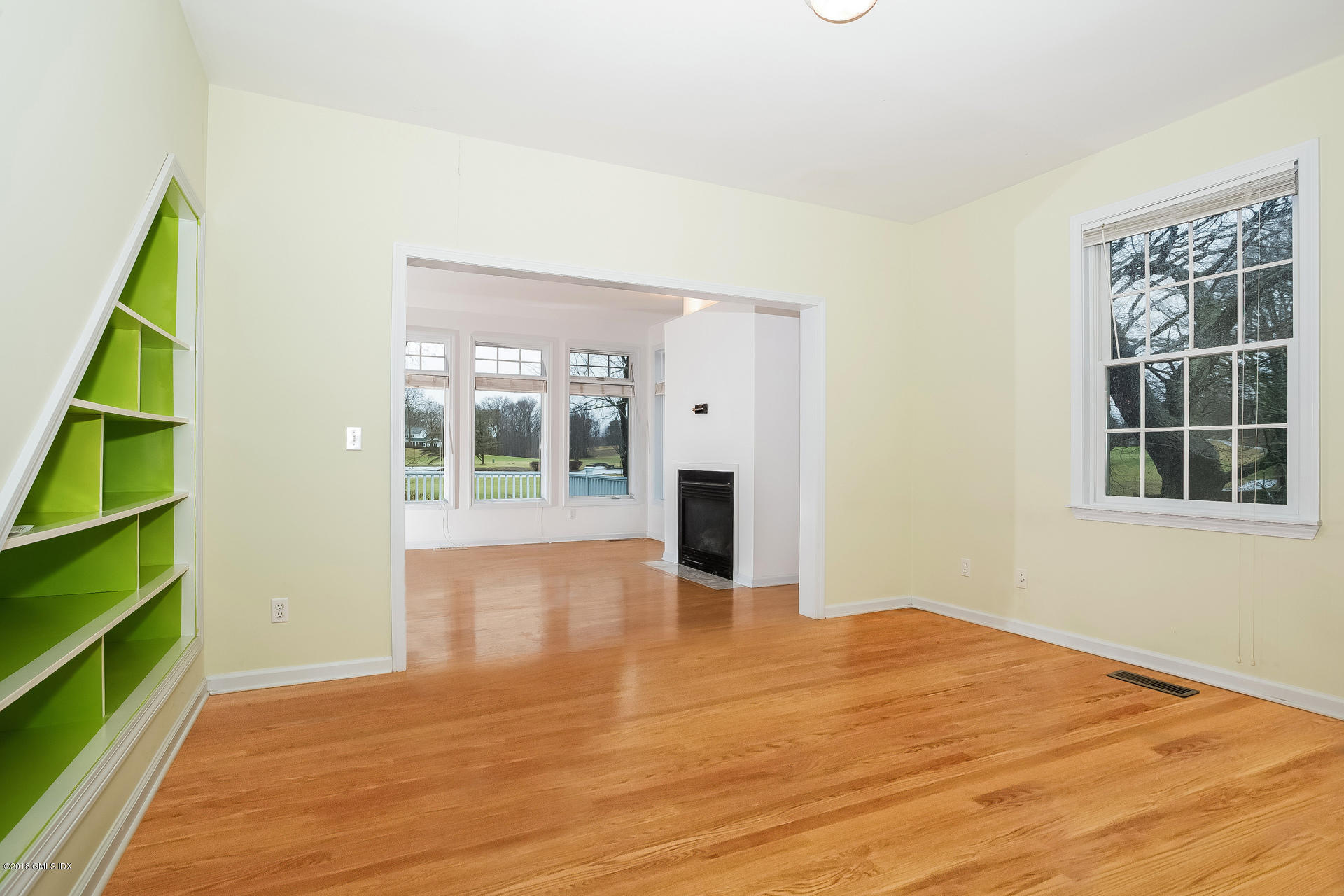 7 Shore Road Old Greenwich, CT 06870 - Photo 29 of 53 a view of an empty room with a window and wooden floor