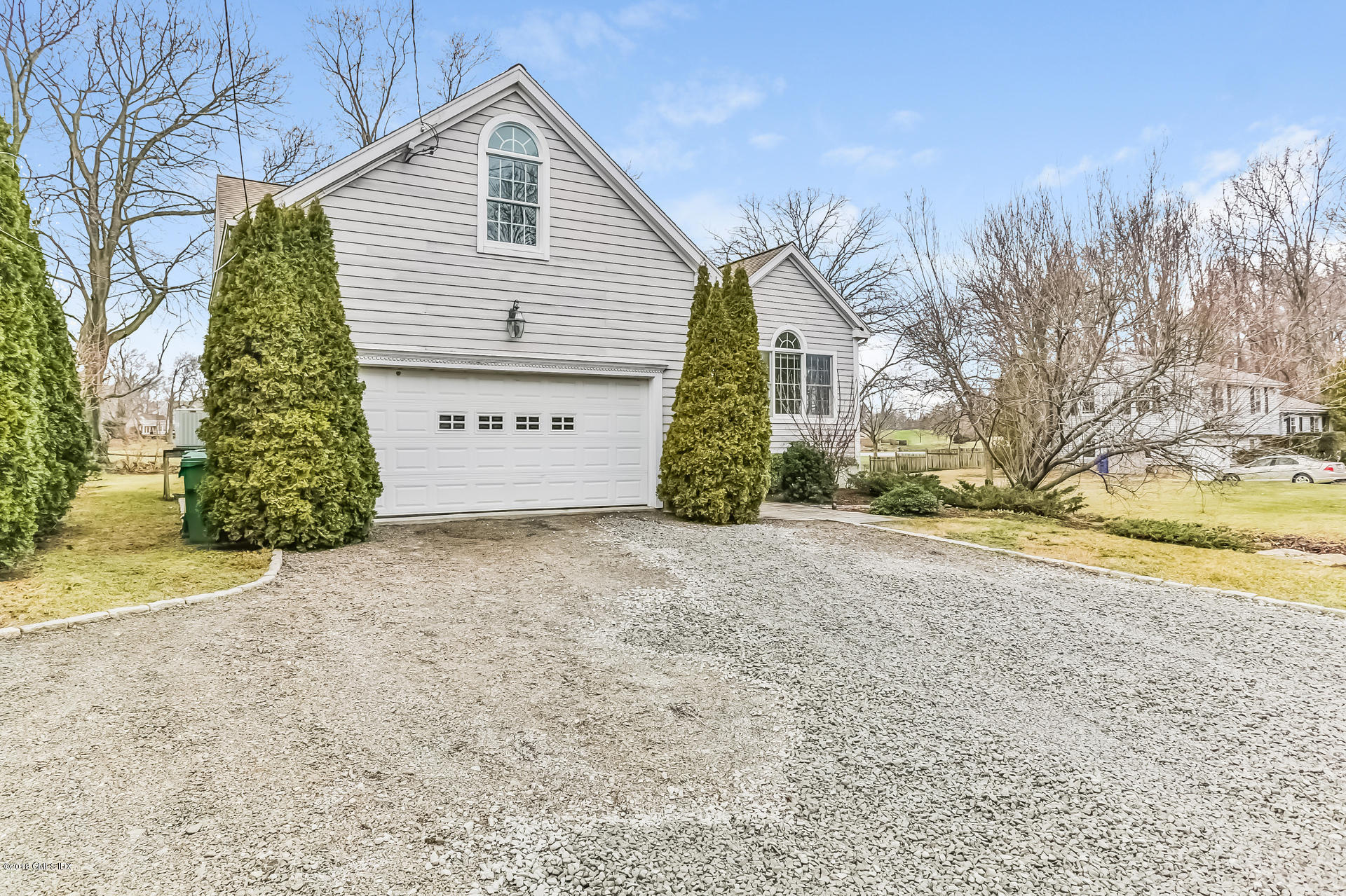 7 Shore Road Old Greenwich, CT 06870 - Photo 3 of 53 a view of a house with a yard and garage