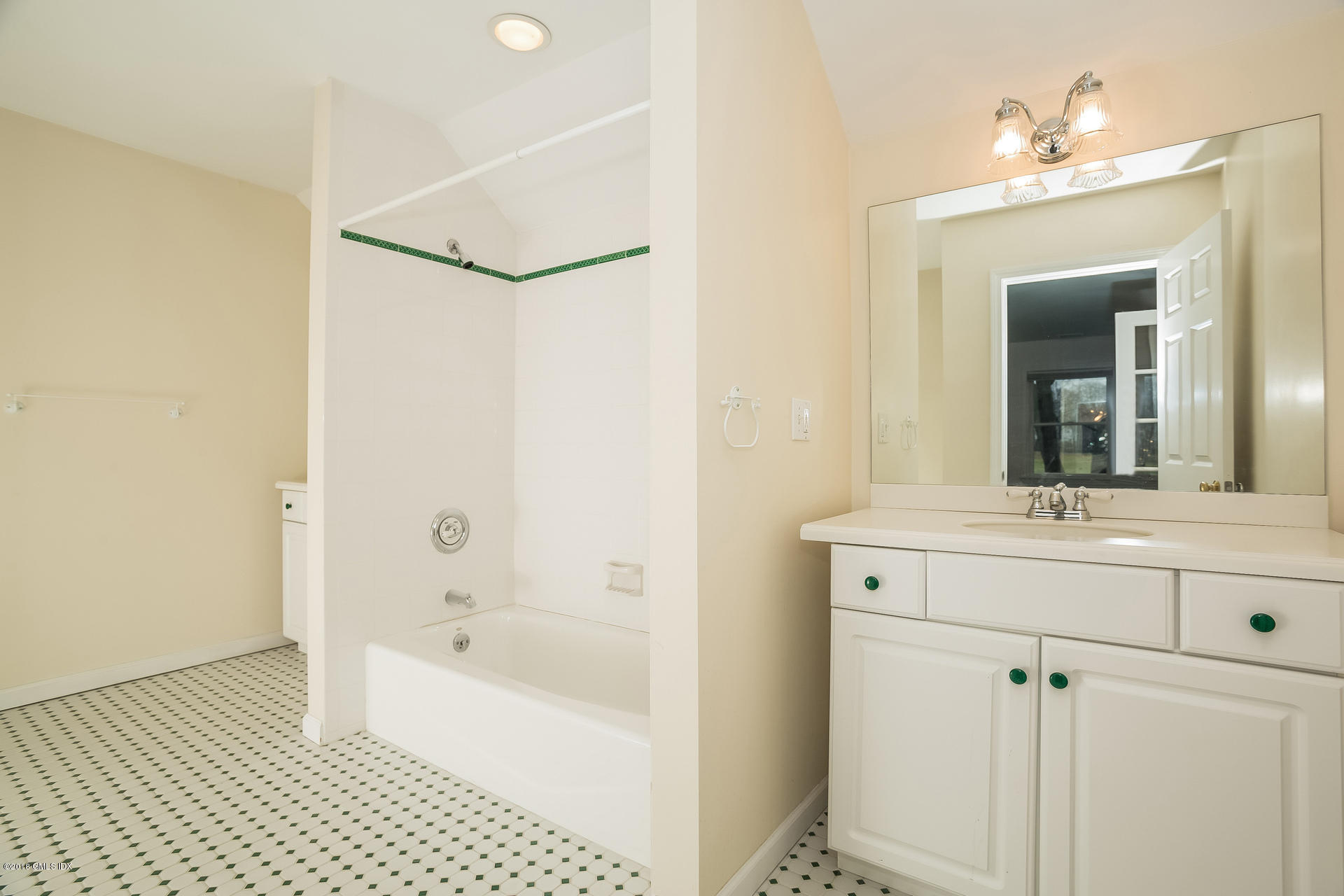 7 Shore Road Old Greenwich, CT 06870 - Photo 44 of 53 a bathroom with a bathtub a sink and a mirror