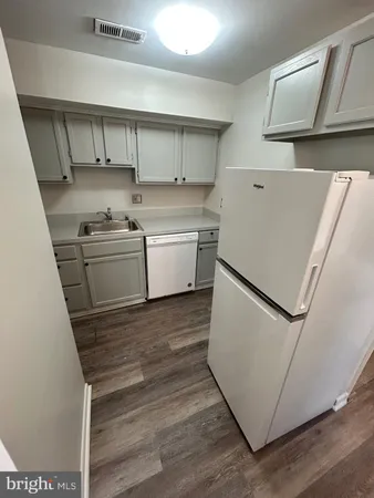 a kitchen with a stove a sink and a refrigerator