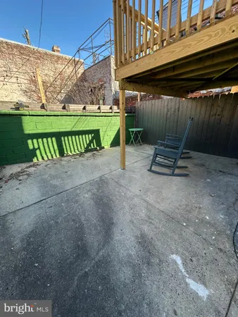 a view of a street with wooden fence