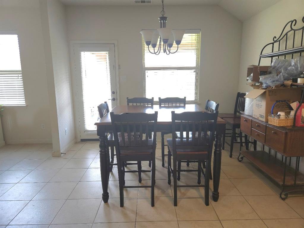 308 Kaylee Way Red Oak, TX 75154 - Photo 11 of 25 Dining area with suspended lighting, light tile patterned flooring, and lofted ceiling