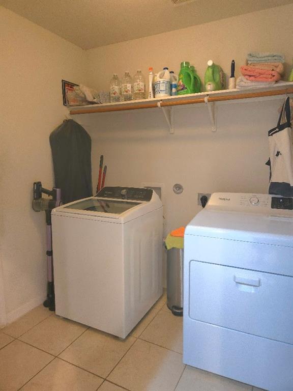 308 Kaylee Way Red Oak, TX 75154 - Photo 12 of 25 Laundry room with light tile patterned flooring and washer and dryer