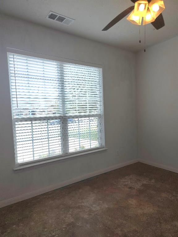 308 Kaylee Way Red Oak, TX 75154 - Photo 13 of 25 Empty room featuring a ceiling fan and dark carpet