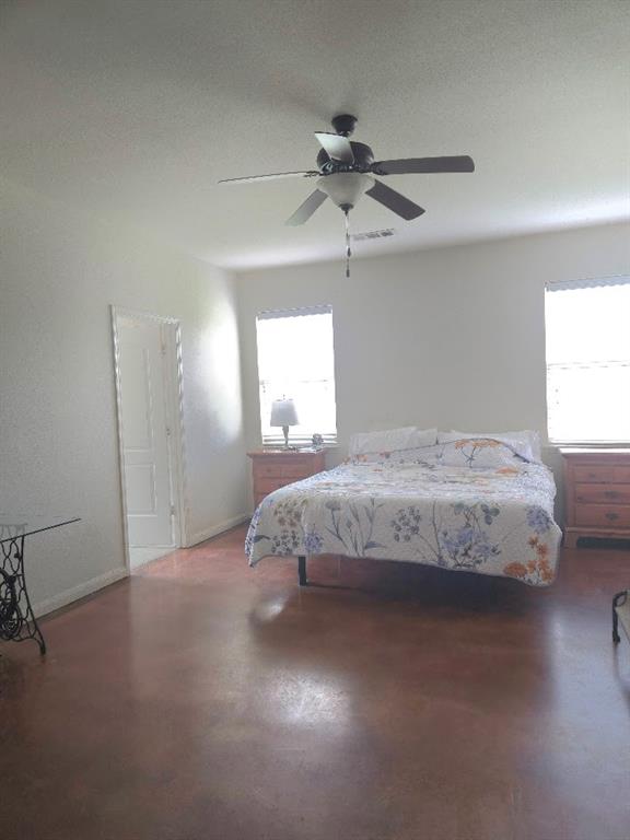 308 Kaylee Way Red Oak, TX 75154 - Photo 22 of 25 Bedroom featuring ceiling fan, finished concrete floors, and multiple windows