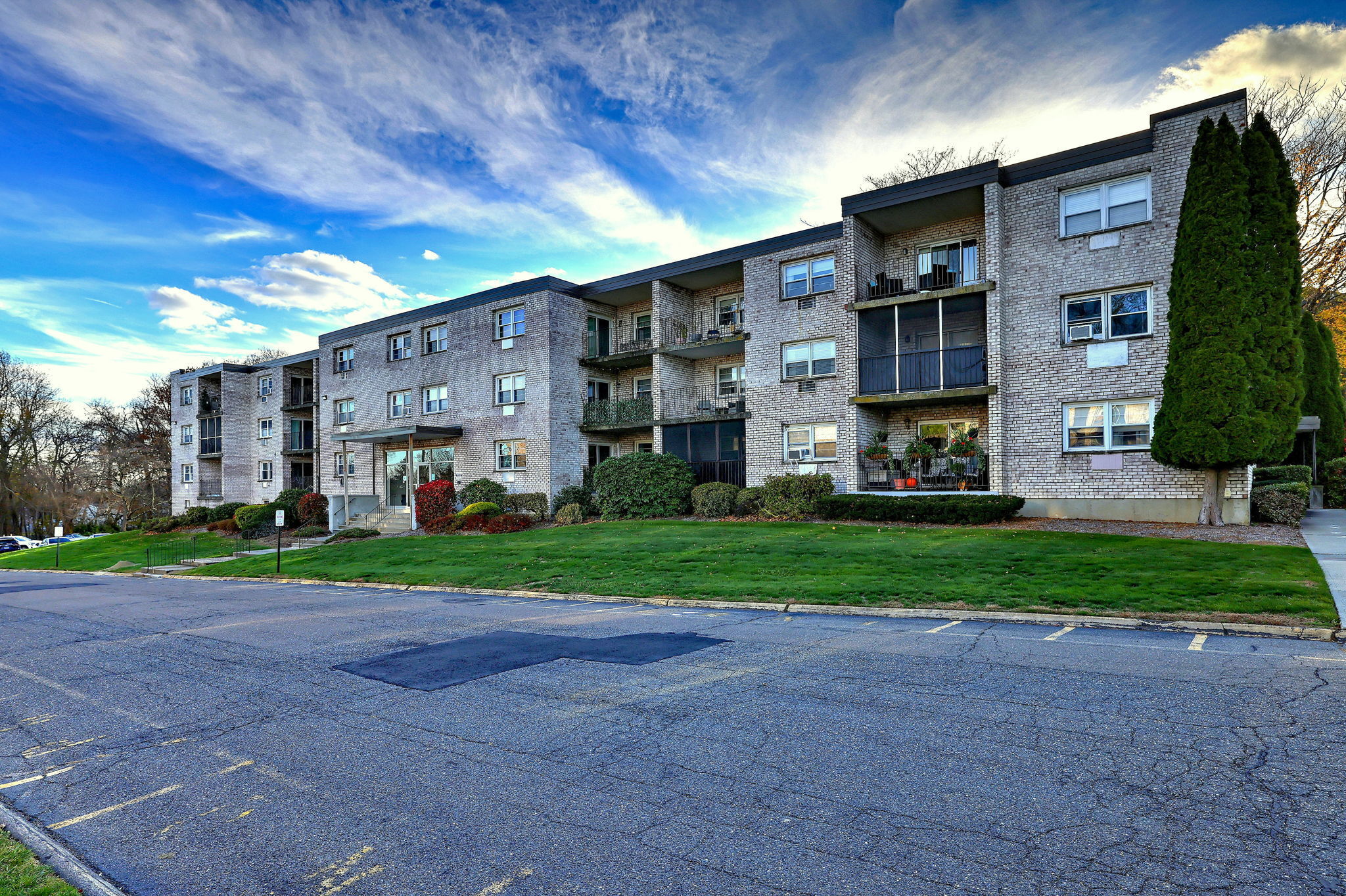 308 Meadowside Road, Unit 202 Milford, CT 06460 - Photo 1 of 40 a view of a big building with a big yard and large trees