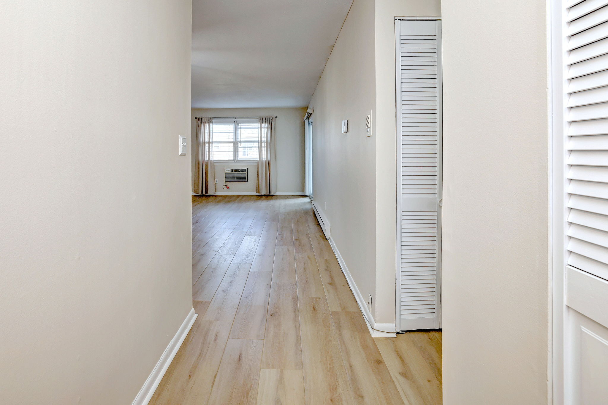 308 Meadowside Road, Unit 202 Milford, CT 06460 - Photo 21 of 40 a view of a hallway with wooden floor and a window