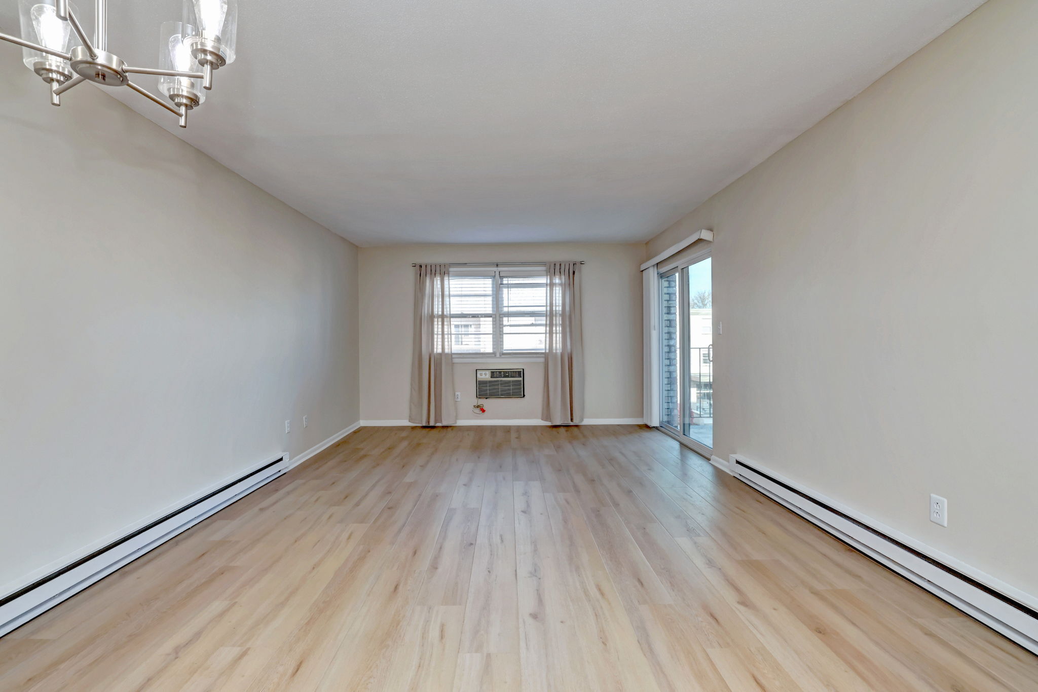 308 Meadowside Road, Unit 202 Milford, CT 06460 - Photo 22 of 40 an empty room with wooden floor and windows