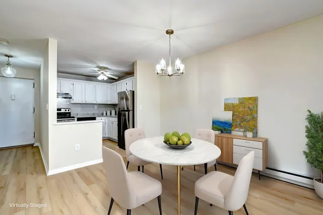 a view of a kitchen with a white cabinets and wooden floor