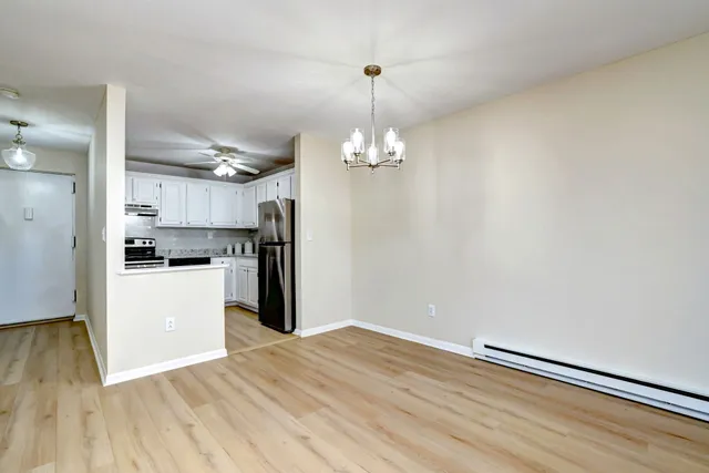 a kitchen with stainless steel appliances granite countertop a stove and white cabinets