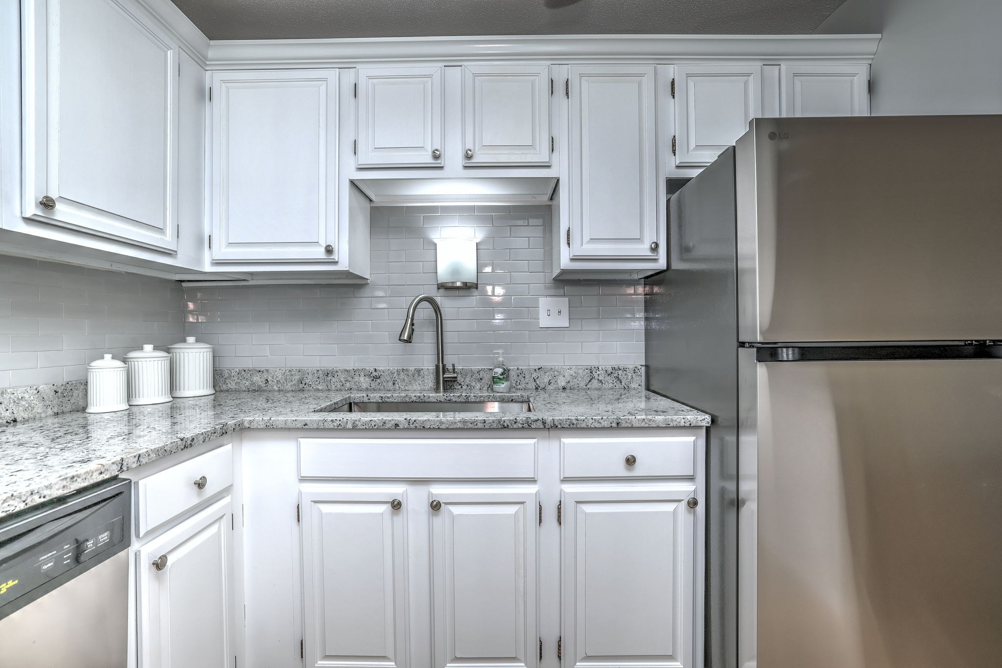 308 Meadowside Road, Unit 202 Milford, CT 06460 - Photo 26 of 40 a kitchen with stainless steel appliances granite countertop a refrigerator sink and cabinets