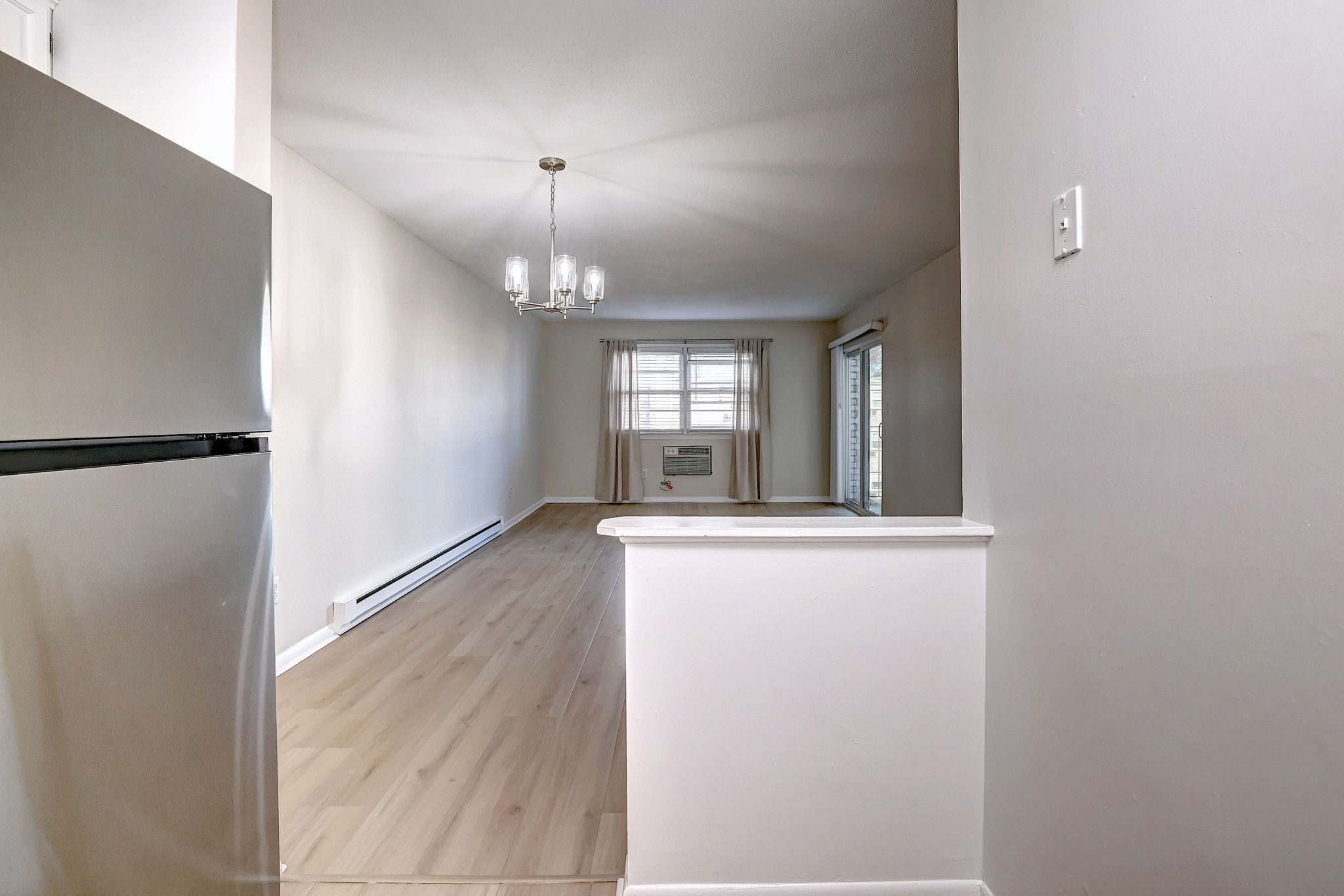 308 Meadowside Road, Unit 202 Milford, CT 06460 - Photo 29 of 40 a view of an empty room with window and wooden floor