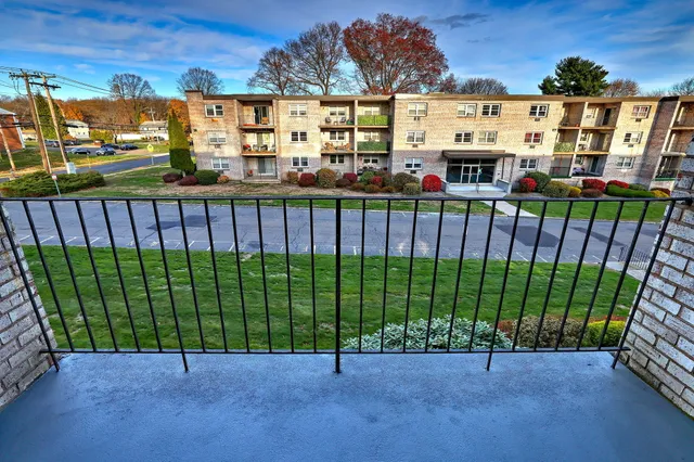 a bathroom with a granite countertop sink toilet a mirror and shower