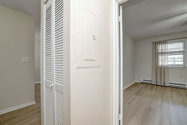 a view of a kitchen with fridge and workspace