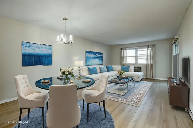 a living room with furniture a table and a flat screen tv