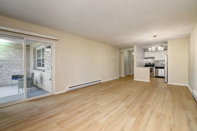 a view of a kitchen with a sink and a refrigerator